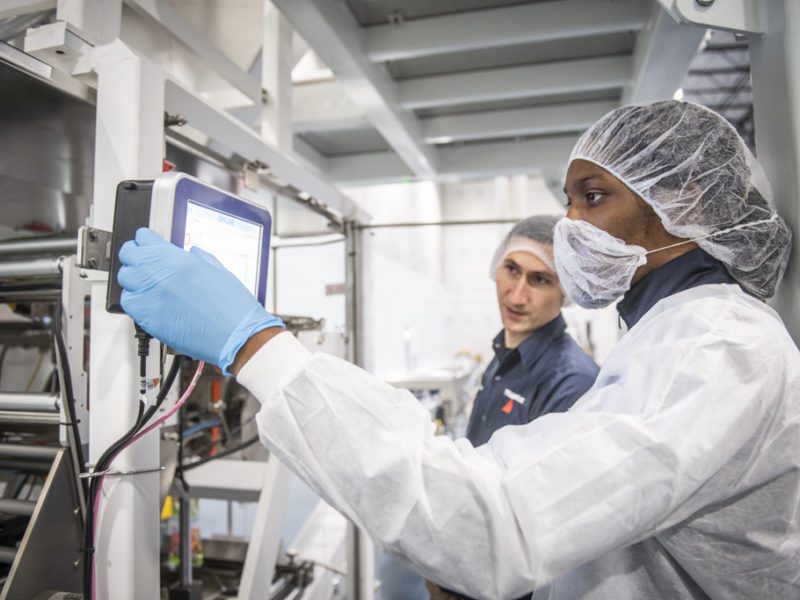 Person wearing hairnets working in lab