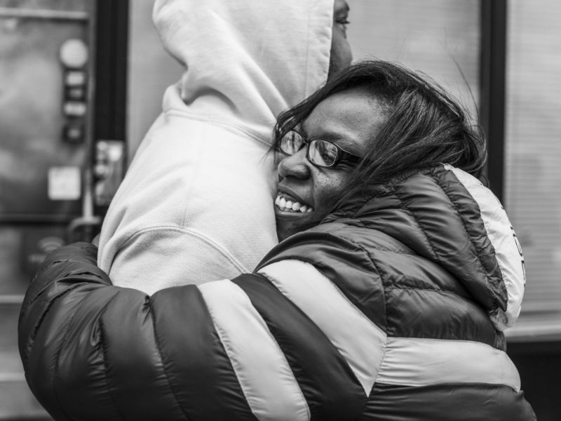 Woman happily hugging man