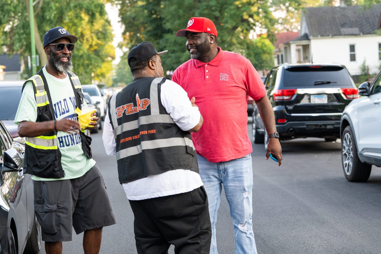 cred outreach workers talking on sidewalk
